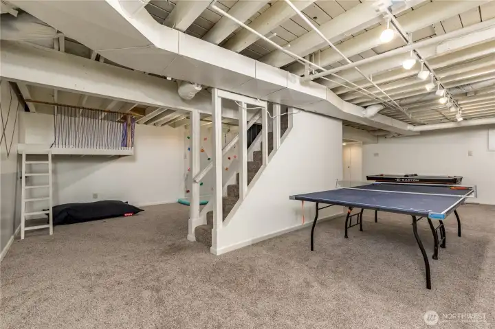 A rec room paradise: The fully-finished basement features a custom play loft, bouldering wall, and plenty of space for games