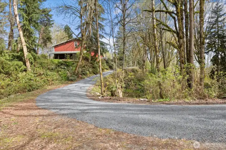 Newly installed gravel driveway with gated entry