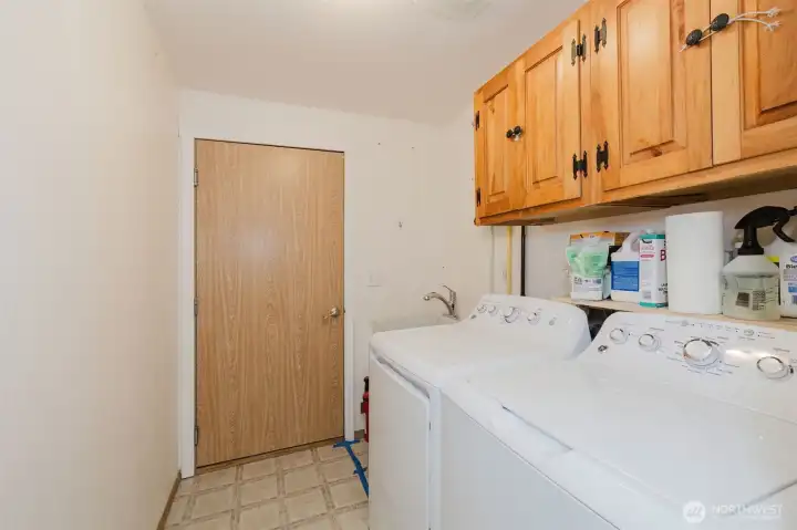 Laundry room leads to converted garage