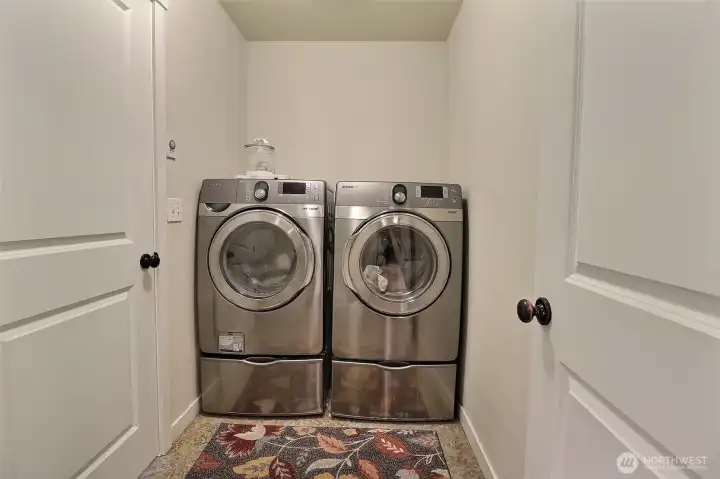 Large laundry room accessed from upstairs hallway AND Primary suite.