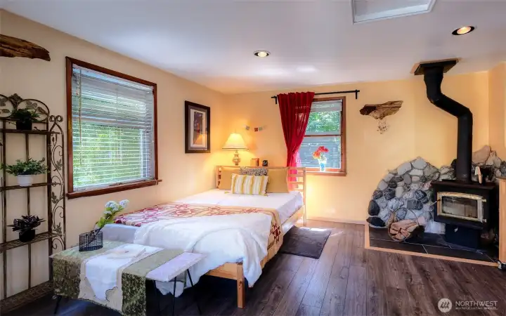 Warm, inviting retreat where you'll want to linger a bit longer. The glass-faced wood stove wrapped w/ custom stone surround fills the room with warmth and a cozy ambiance.