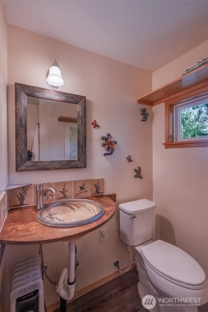 This tastefully curated 3/4 bathroom captures the artistic spirit of the cabin.