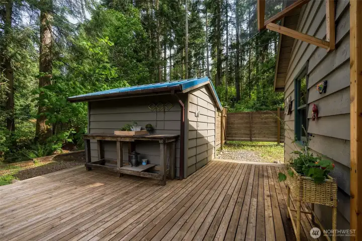 A well-placed storage shed offers added convenience.  A rustic work/serving bench ~ ideal for projects or entertaining.