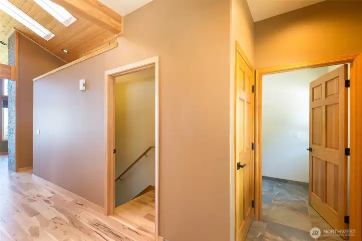 Hallway from entrance with access to laundry room and lower level