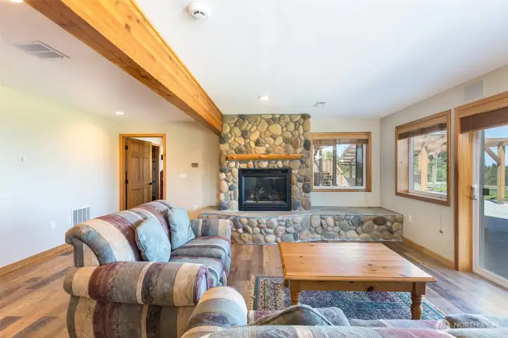 Lower level family room with stone propane fireplace