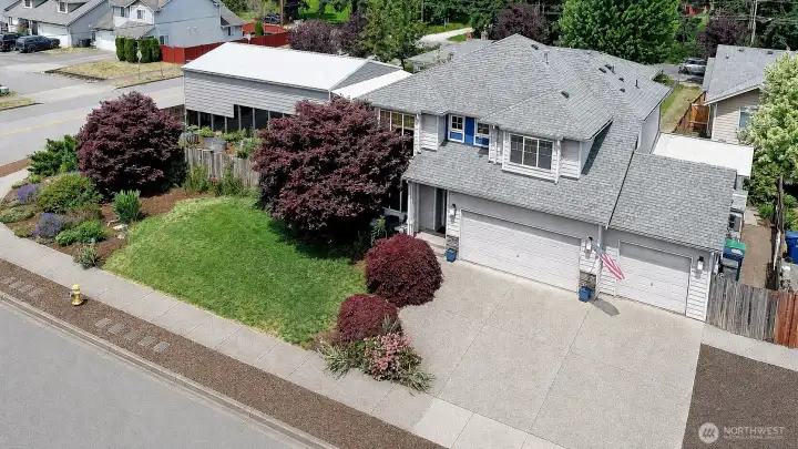 A bird's-eye view highlights the expansive RV parking, 3-car garage, and beautifully maintained grounds.