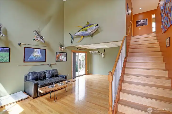 Bright, open entry with impressive ceiling height and elegant staircase.