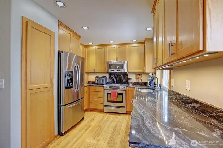 Beautiful kitchen featuring granite countertops, stainless steel appliances, and abundant cabinet storage.