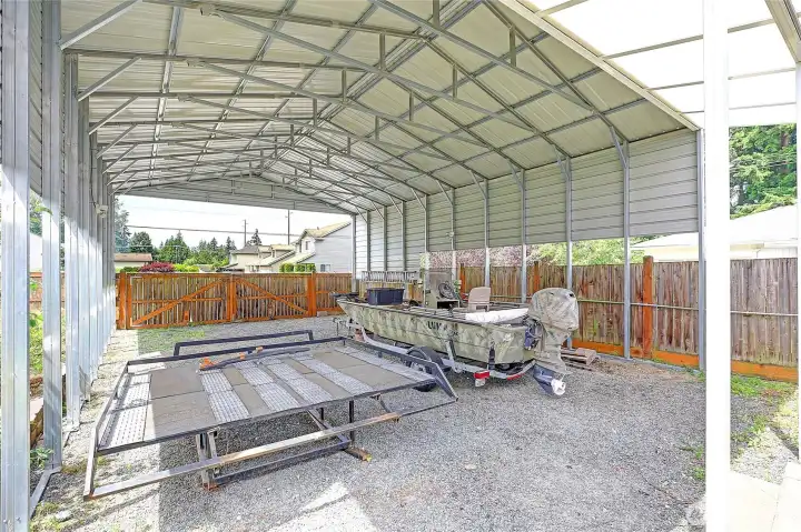 Massive covered RV/boat parking provides space for vehicles, trailers, and recreational toys.