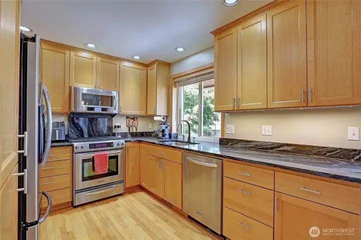 Beautiful kitchen featuring granite countertops, stainless steel appliances, and abundant cabinet storage.