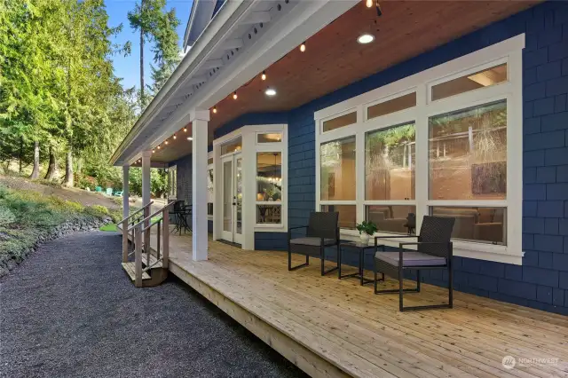 A covered porch lines the back of the home with French doors from the kitchen/living/dining rooms