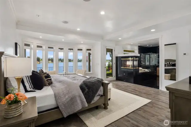 Serene & Stunning Primary Bedroom with sweeping views of the lake.