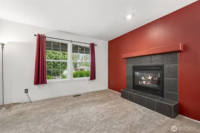 The formal living room includes a warm and inviting gas fireplace.