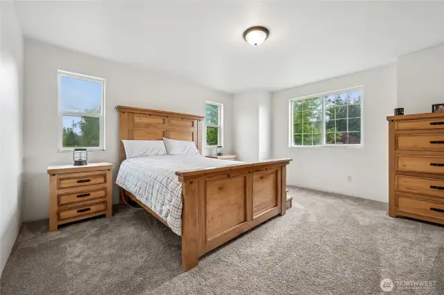 This spacious primary bedroom provides a private haven with ample room to relax and recharge.