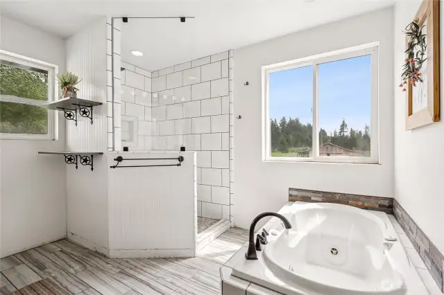 Indulge in everyday luxury with a beautifully designed primary ensuite complete with a tile shower and soaking tub.