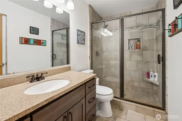 A charming hall bath with a classic look and a beautifully tiled shower for everyday ease.