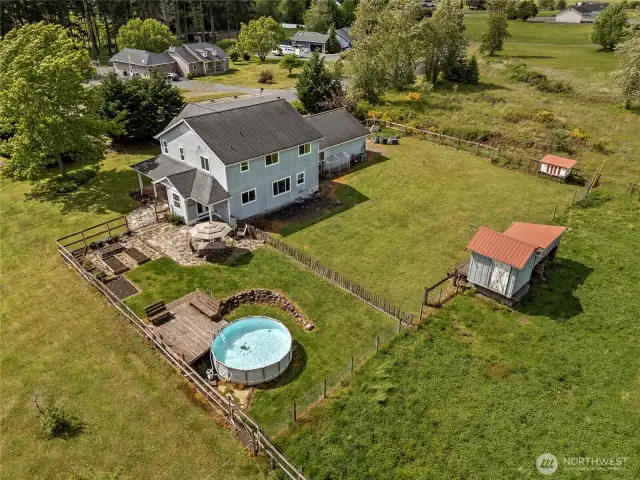 The immediate homestead area offers outdoor living at its best with a pool, deck, fenced yard, garden beds, and terrace all just steps from the home.