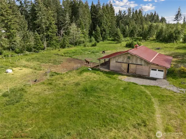Surrounded by green pastures, this newer barn is the perfect blend of utility and rural charm.