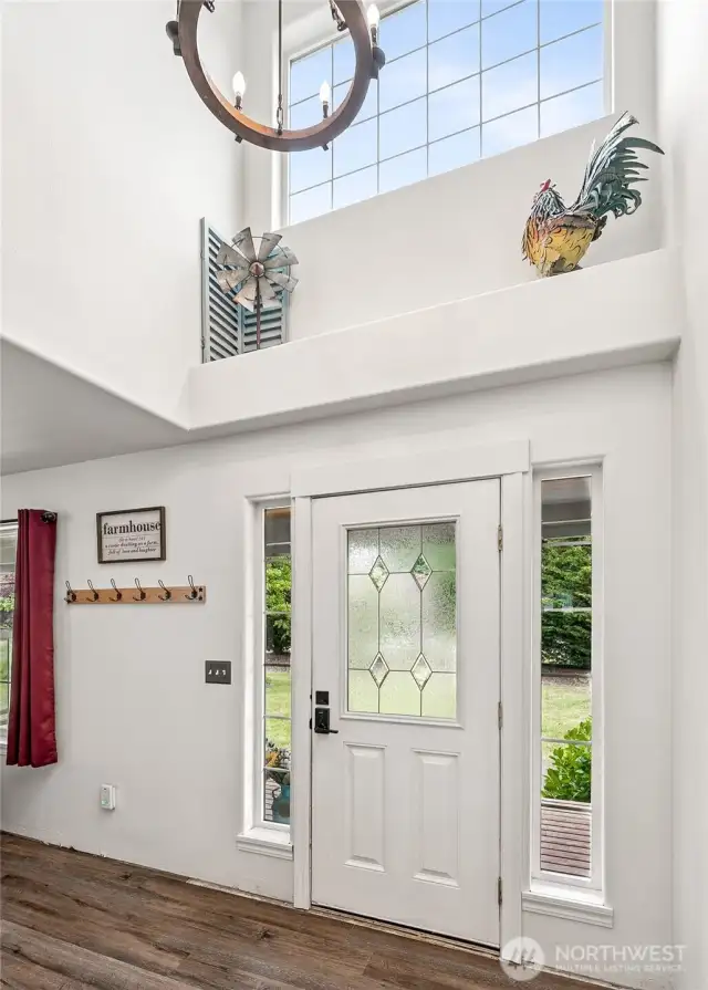 Step into a stunning vaulted foyer bathed in natural light—where space and style greet you at the door.