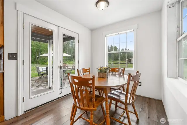 The sunlit breakfast nook provides direct access to the back terrace—ideal for seamless indoor-outdoor gatherings.