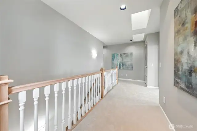 Ascend the staircase to the second level complete with a wide landing with high ceilings and skylights.
