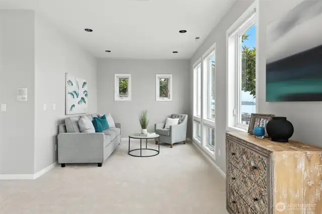 The sitting area in the primary suite is the perfect place to relax, read a book, have a cup of coffee and watch all of the boating activity and sea planes right out your windows.