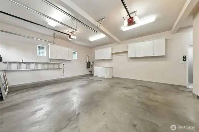 This attached, large, two car garage boasts high ceilings, storage cabinets and a drop-down attic space for loads of additional storage options.