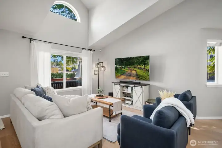 Enter into Living Room with vaulted ceiling and natural lighting. TV mount will remain
