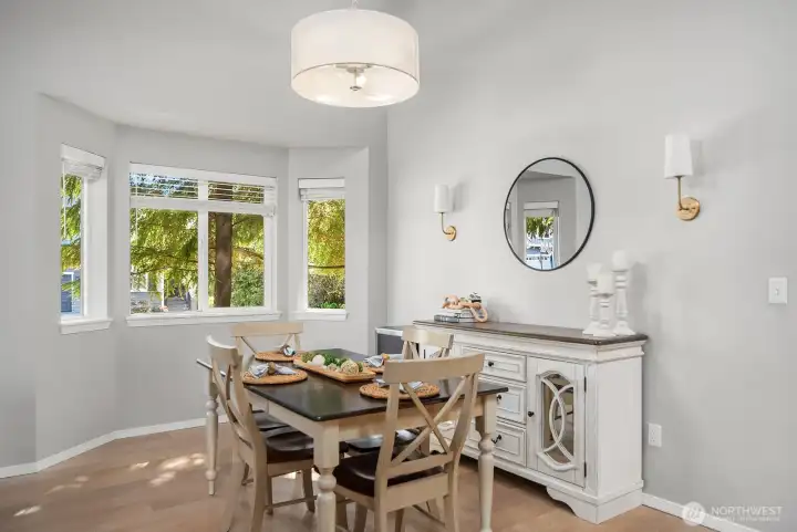 Dining room with high ceilings, a bay window with views of the yard