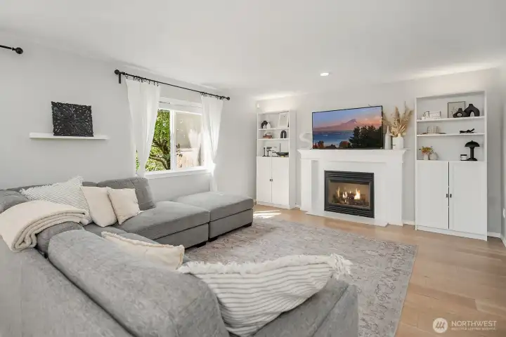 Family Room has a cozy gas fireplace focal point and cabinets added around fireplace for extra display