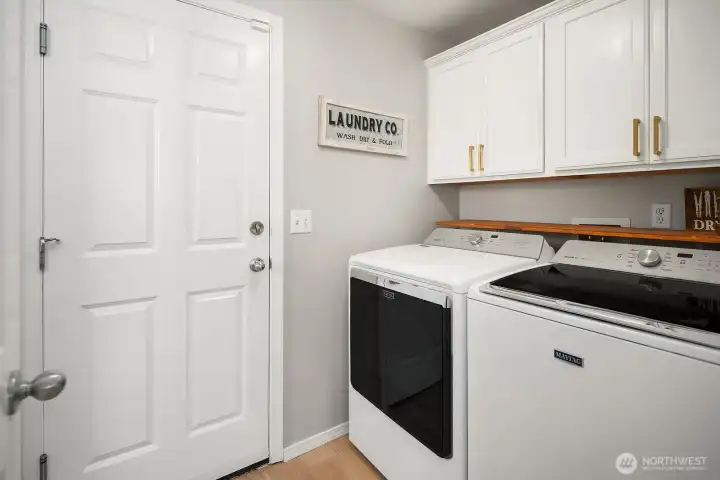 Maytag Washer and Dryer with upper cabinets to stay organized.