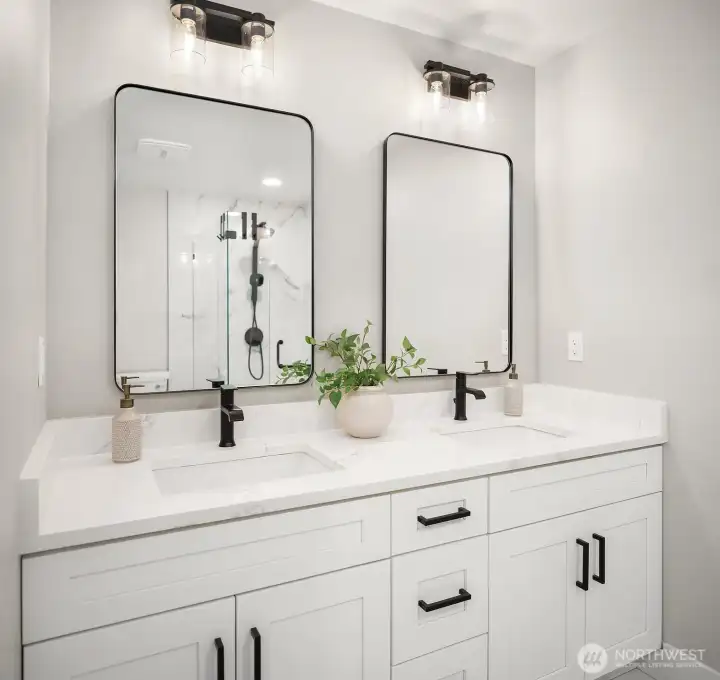 Double white vanity with dual sinks, granite countertop, new mirrors, new plumbing fixtures, and new light fixtures.
