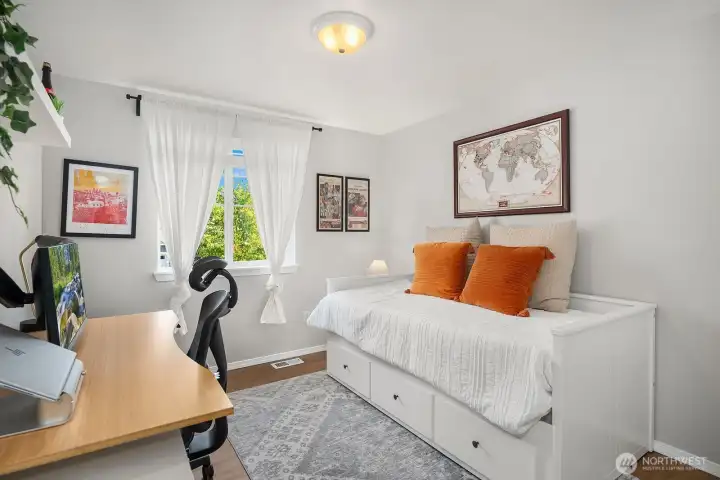 4th bedroom/home office/ guest space with custom closet system and faux wood blinds.