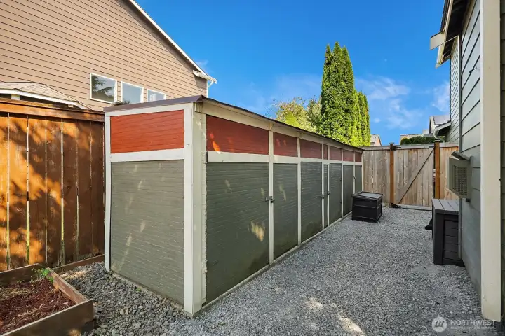 Following the gravel pathway past the air conditioning unit through the side gate where there is a long storage shed for all your sports equipment and outdoor hobbies.