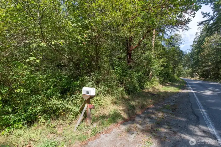The southern property marker on the Discovery Road side is just a few feet north of the 3090 mailbox.