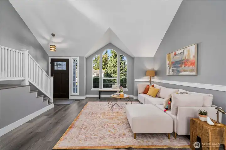 Enter into a spacious, vaulted ceiling living room.