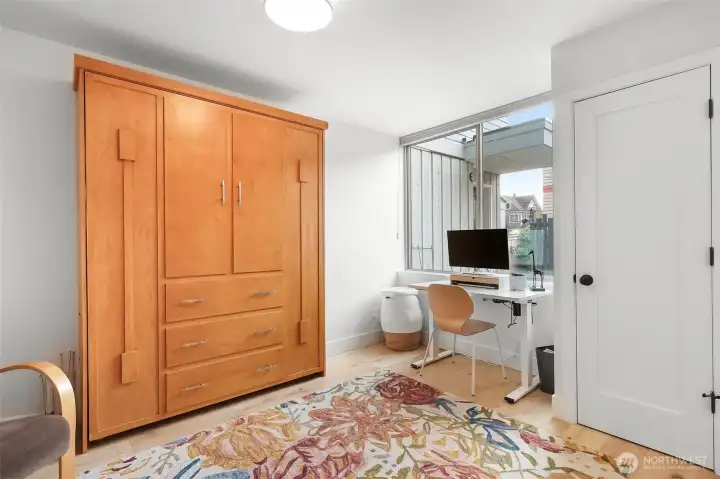 This room makes a cheerful office with loads of closet space.
