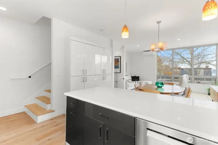 View from kitchen of stairs to primary suite and rooftop deck.