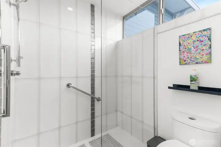 Primary bath features sleek and updated finishes.