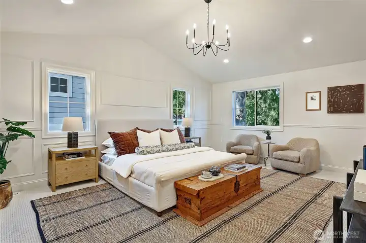 Top floor primary bedroom suite includes soaring vaulted ceilings.