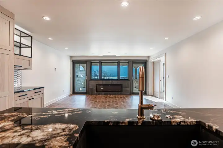 Striking solid slab marble kitchen counters and stylish gold fixtures are highlights in the kitchen with lake views always in sight.