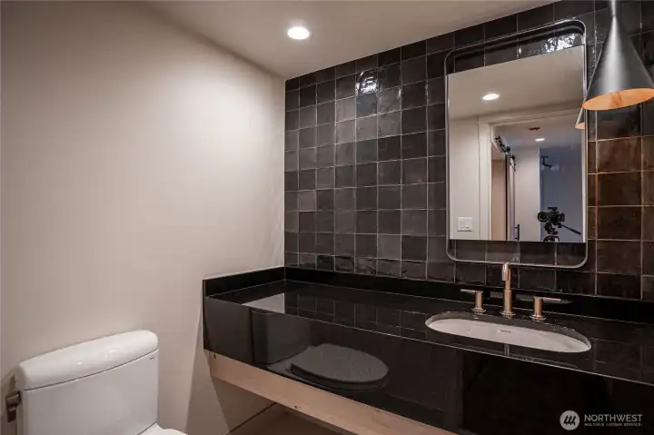 Stylish and modern half-bath in the entry area.