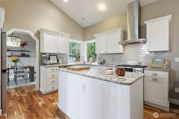 Updates have included granite countertops, backsplash, cabinets, and appliances.  The wood laminate flooring throughout the main floor is lovely!!