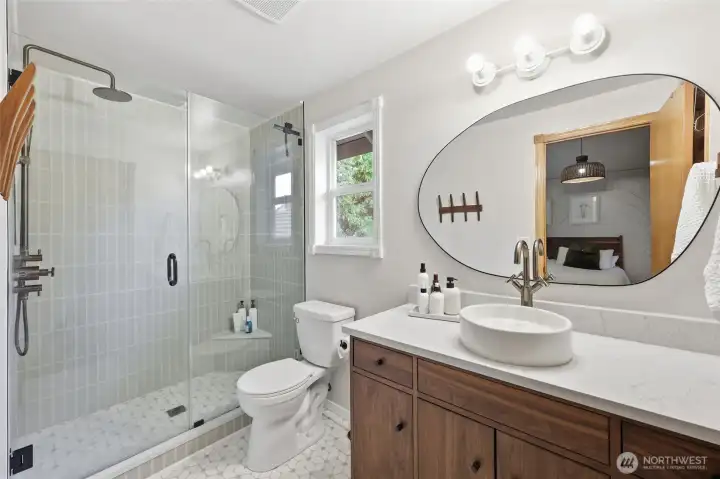 Beautifully remodeled primary bathroom:  shower stall re-tiled, as well as floor! Quartz countertop...updated sink.