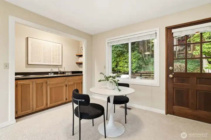 wet bar and seating with access to generously sized deck