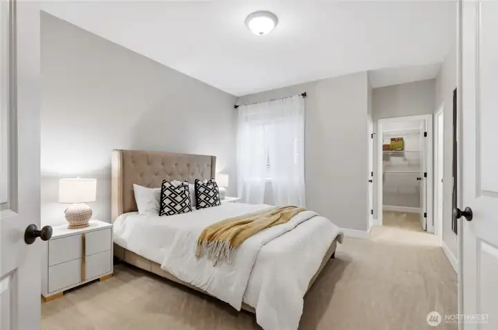 Versatile main floor suite with walk-in closet and en-suite bathroom.