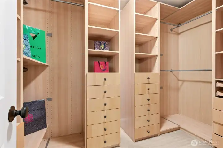 Primary suite walk-in closet w/ custom built-ins to maximize storage.