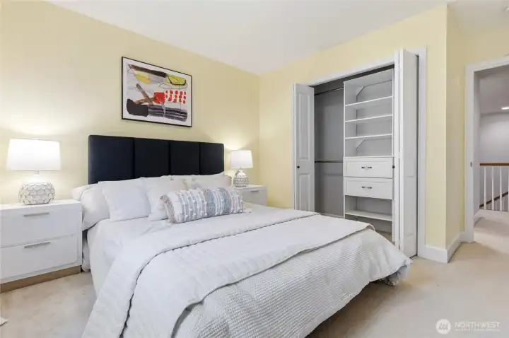 Spacious secondary bedroom with custom closet built-ins.