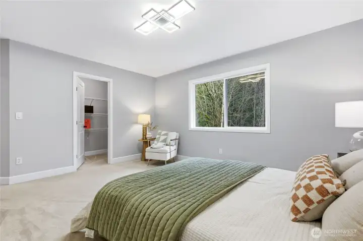 Large bedroom with walk-in closet and backyard and greenbelt views.