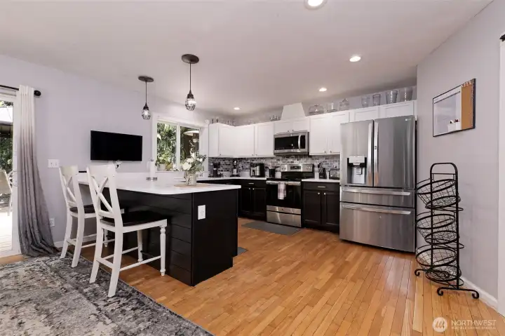 Beautiful kitchen with granite counter tops and real hardwood floors. Slider leads out to a wonderful large deck.
